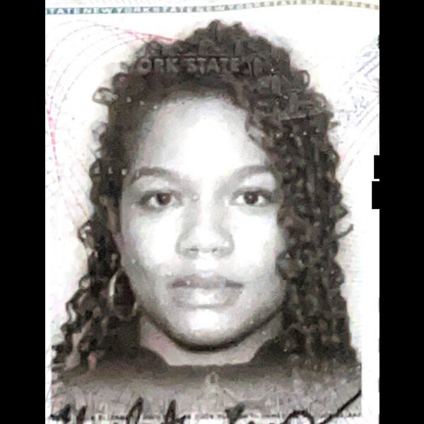 A cropped headshot from Elizabeth's drivers license. In black and white, she looks directly at the camera. She has long curly black hair and one large hoop earring is visible.